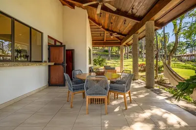 a patio with a wooden table and chairs at Casa Carmen in Potrero