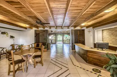 a dining room with a wooden ceiling and a table and chairs at Lovely Condo (8 people): Pools, Tennis Courts, BBQ in Manuel Antonio