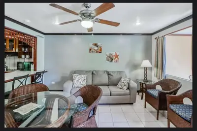 a living room with a couch and a table at Lovely Condo (8 people): Pools, Tennis Courts, BBQ in Manuel Antonio