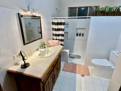 a bathroom with a sink and a toilet and a mirror at daBene - Bed & Breakfast in Alajuela City