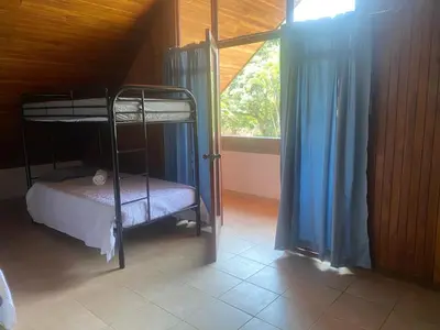 a bedroom with two bunk beds and a window at daBene - Bed & Breakfast in Alajuela City