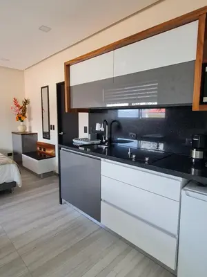 a kitchen with a black and white counter top at Cute Escazú Loft -Great view- in Escazu