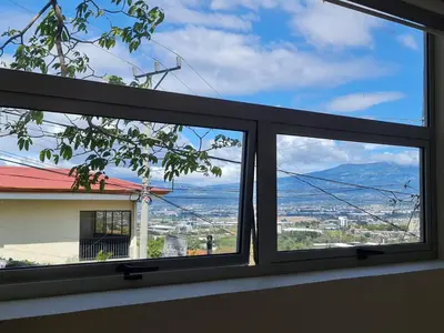 a window with a view of a city at Cute Escazú Loft -Great view- in Escazu