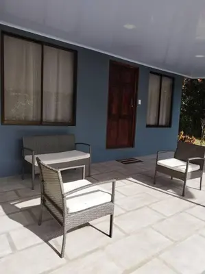 a patio with two chairs and a table and two chairs at Tiny house PZ in San Rafael Norte