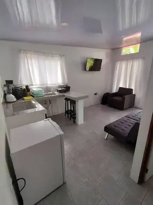 a living room with a couch and a table at Tiny house PZ in San Rafael Norte
