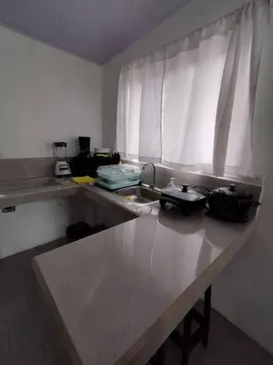 a kitchen counter with a sink and a window at Tiny house PZ in San Rafael Norte
