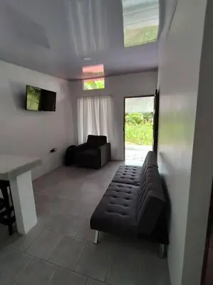 a living room with a couch and a table at Tiny house PZ in San Rafael Norte