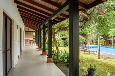 an external corridor of a house with a pool at Casa Mapache in Tamarindo
