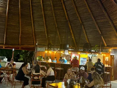 a group of people sitting at tables in a restaurant at Nicoya Silvestre in Lepanto