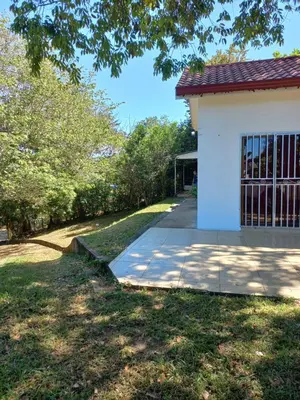 a house with a sidewalk next to a building at Casa Montañas Nicoyanas in Juan Díaz