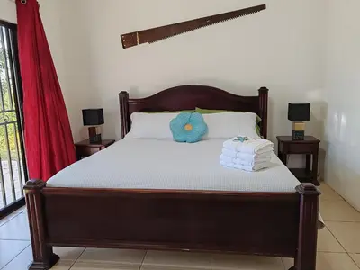 a bedroom with a bed with two towels on it at Casa Montañas Nicoyanas in Juan Díaz