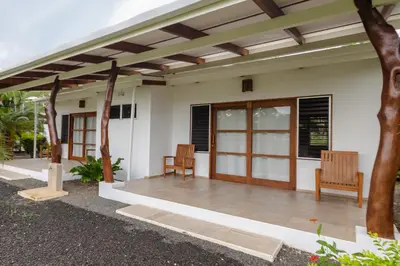 a patio of a house with two chairs at Salvatierra Beachfront Hotel in Puerto Coyote