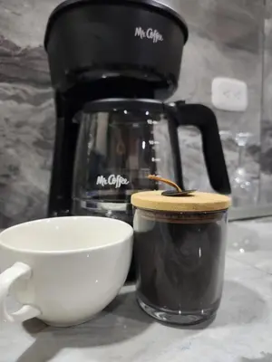 a coffee pot and a cup on a counter at Arenal Memories. in Fortuna