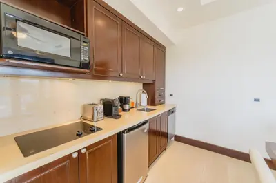 a kitchen with a sink and a microwave at 360 Splendor 104B-Ocean View Condo-Breakfast in Playa Flamingo