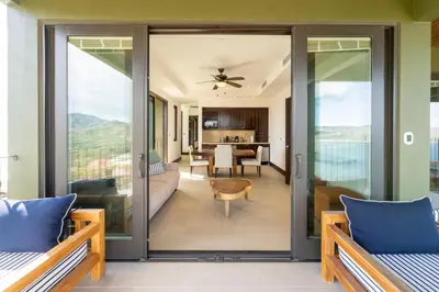 an open living room with sliding glass doors at 360 Splendor 104B-Ocean View Condo-Breakfast in Playa Flamingo