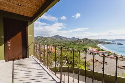 a balcony with a view of the beach at 360 Splendor 104B-Ocean View Condo-Breakfast in Playa Flamingo