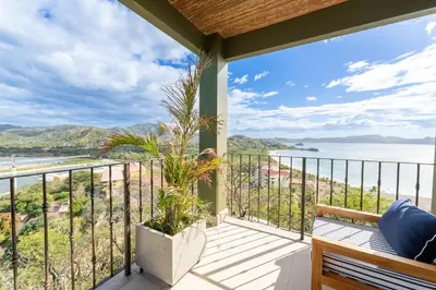 a balcony with a view of the ocean at 360 Splendor 104B-Ocean View Condo-Breakfast in Playa Flamingo