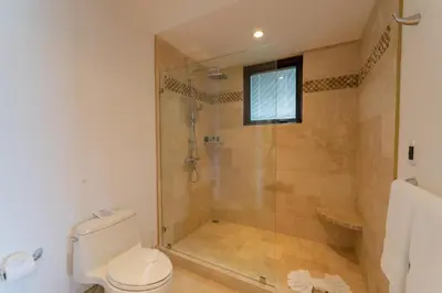 a bathroom with a shower and a toilet at 360 Splendor 104A-Ocean View Condo With Breakfast in Playa Flamingo