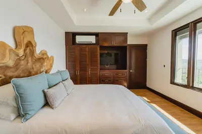 a bedroom with a large bed and a window at 360 Splendor 104F Ocean View 3Br Breakfast in Playa Flamingo