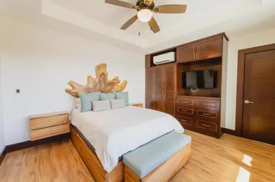 a bedroom with a bed and a ceiling fan at 360 Splendor 104F Ocean View 3Br Breakfast in Playa Flamingo