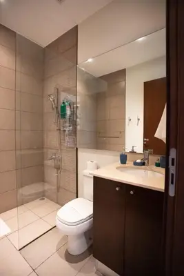 a bathroom with a toilet and a shower and a sink at CasaGuana in Playa Hermosa