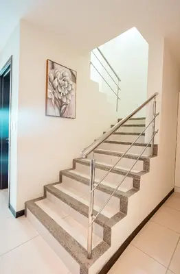a staircase in a house with a painting on the wall at CasaGuana in Playa Hermosa