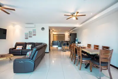 a living room with a couch and a table at CasaGuana in Playa Hermosa