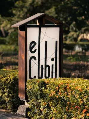 a sign that says eliden in a bush at CasaGuana in Playa Hermosa