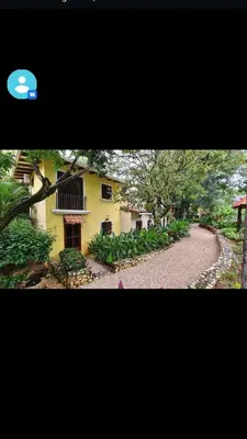 a yellow house with a winding road in front of it at House in Tamarindo Pueblo del mar in Tamarindo
