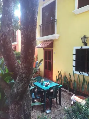 a table and chairs in front of a house at House in Tamarindo Pueblo del mar in Tamarindo