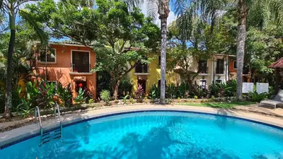 a swimming pool in front of a house at House in Tamarindo Pueblo del mar in Tamarindo