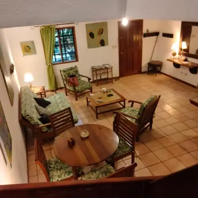 a living room with a table and chairs at House in Tamarindo Pueblo del mar in Tamarindo