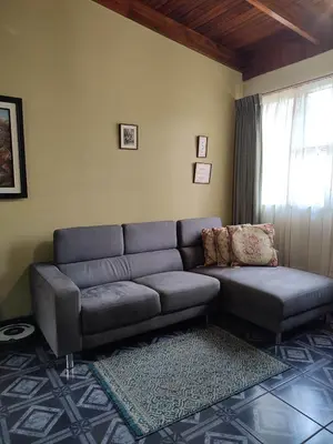 a living room with a couch and a window at The Cozy Cactus House B&B Cartago Centro English Spoken in Cartago