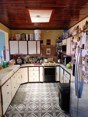 a kitchen with a refrigerator and a tile floor at The Cozy Cactus House B&B Cartago Centro English Spoken in Cartago