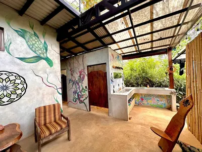 a room with a painting on the side of a wall at Shipwrecked Hostel in Uvita
