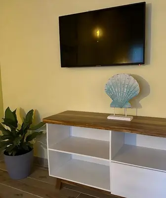 a entertainment center with a flat screen tv on a wall at Hotel Villas Gaia Ecolodge in Uvita