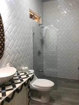 a bathroom with a toilet and a glass shower at Hotel Villas Gaia Ecolodge in Uvita