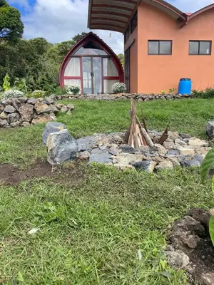 a stone wall in front of a house at Glamping Campo Alegre in Cartago