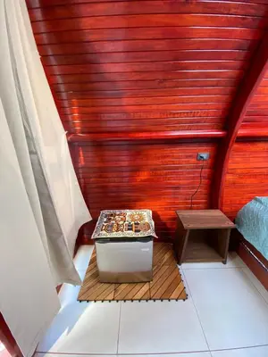 a small sauna with a table and a bench at Glamping Campo Alegre in Cartago