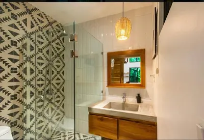 a bathroom with a sink and a glass shower at Condo VNV walking distance to the beach in Nosara