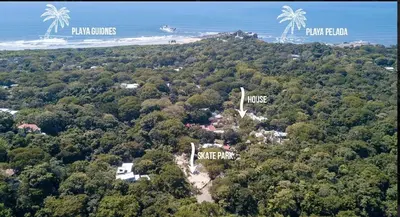 an aerial view of a resort with palm trees and a beach at Condo VNV walking distance to the beach in Nosara