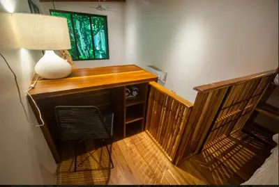 a desk with a lamp and a chair in a room at Condo VNV walking distance to the beach in Nosara
