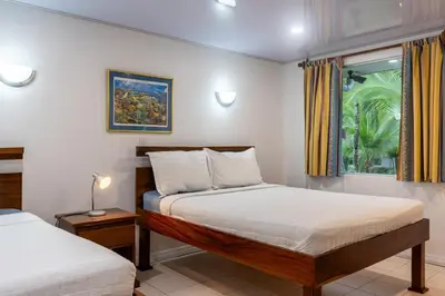 a bedroom with two beds and a window at Laguna Eco Village #205 Pool/ Tennis Courts/ BBQ in Quepos