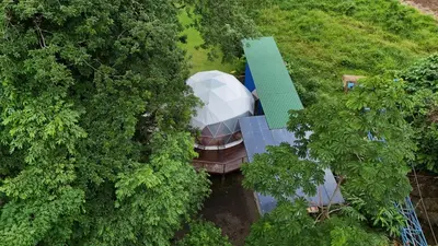 an overhead view of a house in the middle of trees at Bitzu Dome-Bijagua Riverside Glamping in Bijagua