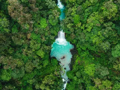 an aerial view of a river in the middle of a forest at Bitzu Dome-Bijagua Riverside Glamping in Bijagua