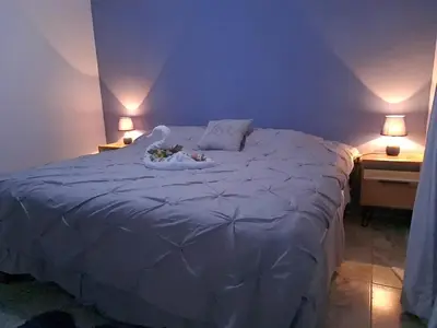 a bedroom with a bed with two animals laying on it at Casa vista de luna in Guaria