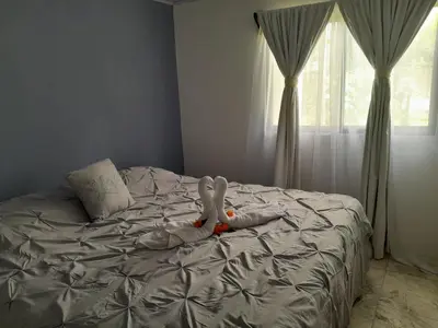 a bed with two stuffed animals laying on it at Casa vista de luna in Guaria