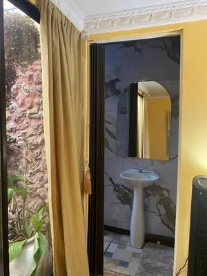 a bathroom with a sink and a mirror at Casa Lupita Alajuela in Alajuela City