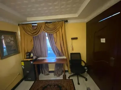 a desk and a chair in a room with a window at Casa Lupita Alajuela in Alajuela City