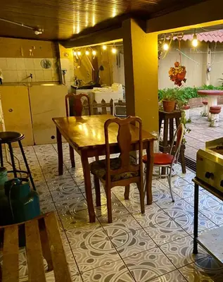 a dining room with a wooden table and chairs at Casa Lupita Alajuela in Alajuela City